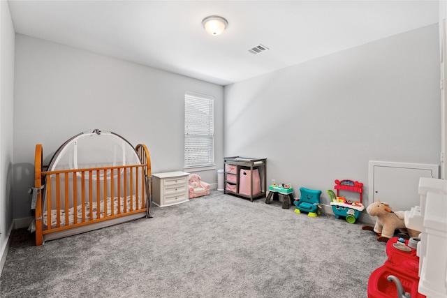 carpeted bedroom featuring a nursery area and visible vents