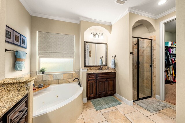 bathroom with a shower stall, vanity, a tub with jets, a walk in closet, and crown molding