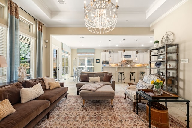 living room with light tile patterned floors, plenty of natural light, a notable chandelier, and ornamental molding