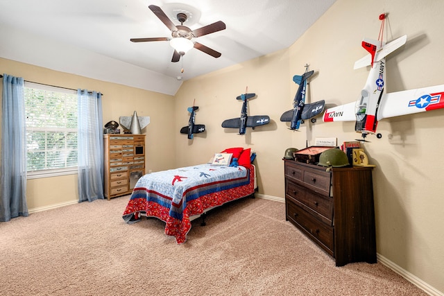 bedroom featuring ceiling fan, baseboards, carpet flooring, and vaulted ceiling