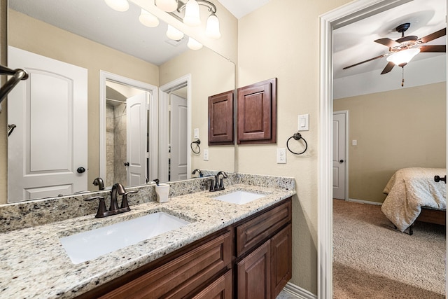 bathroom with ceiling fan, ensuite bath, a sink, and double vanity