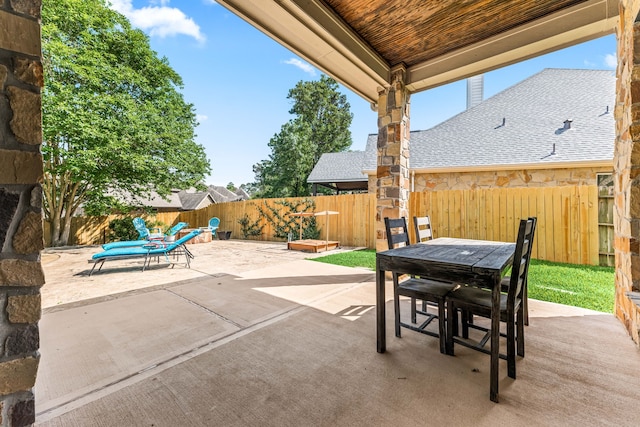 view of patio with a fenced backyard and outdoor dining area