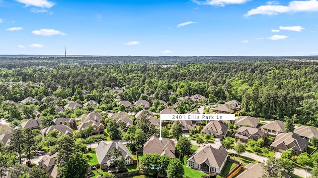 aerial view featuring a forest view and a residential view