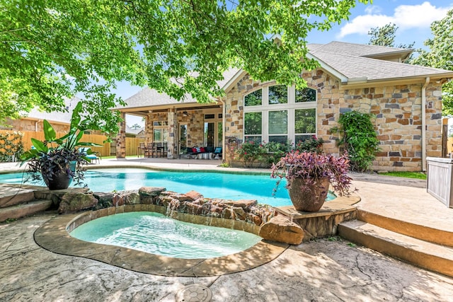 view of pool with a patio area, a fenced backyard, ceiling fan, and a pool with connected hot tub