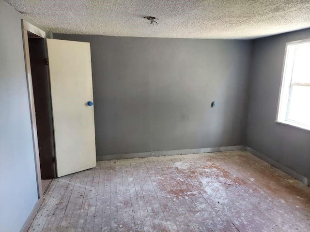 108 E Mcgee Rd, New Boston, TX 75570 - unfurnished room with hardwood / wood-style floors and a textured ceiling