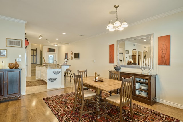102 Capetown Slip, Conroe, TX 77356 - dining room with light wood-style floors, crown molding, a chandelier, recessed lighting, and baseboards