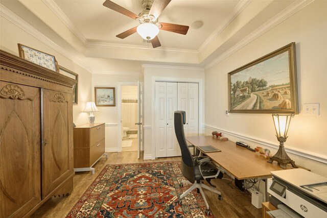 102 Capetown Slip, Conroe, TX 77356 - office area featuring light wood-type flooring, ceiling fan, a raised ceiling, and crown molding