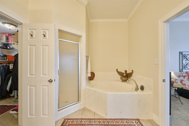 102 Capetown Slip, Conroe, TX 77356 - bathroom with a stall shower, a garden tub, ornamental molding, a walk in closet, and tile patterned floors