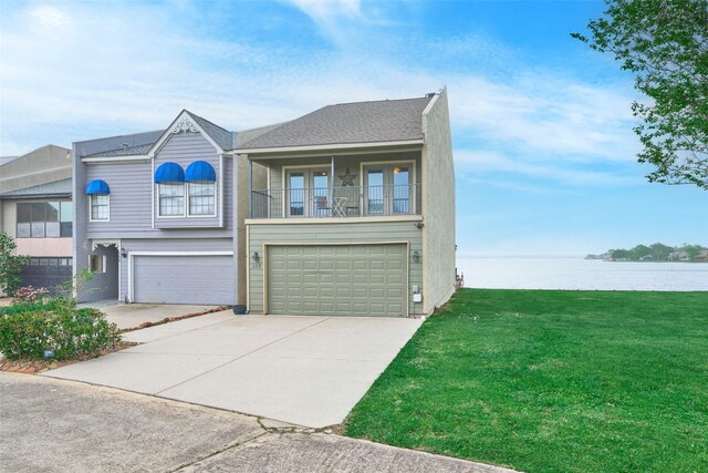102 Capetown Slip, Conroe, TX 77356 - view of front of home with a front yard, a water view, driveway, an attached garage, and a balcony