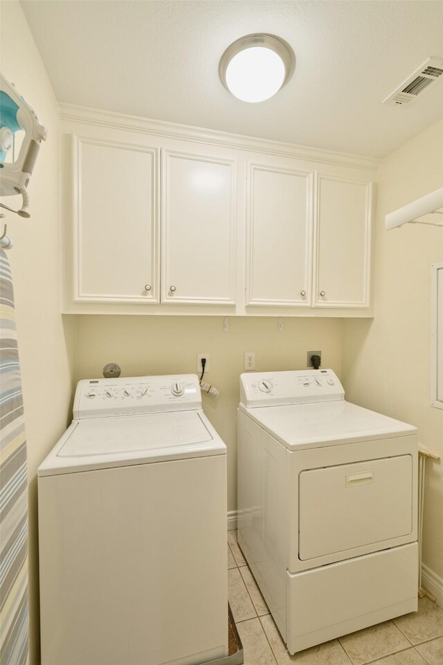 102 Capetown Slip, Conroe, TX 77356 - laundry area featuring cabinet space, washer and dryer, light tile patterned flooring, and baseboards