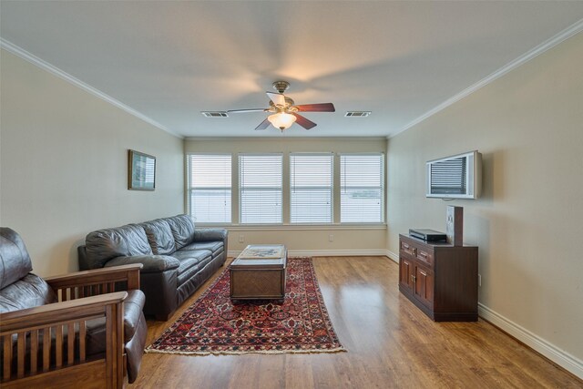 102 Capetown Slip, Conroe, TX 77356 - living room featuring a ceiling fan, healthy amount of natural light, wood finished floors, crown molding, and baseboards
