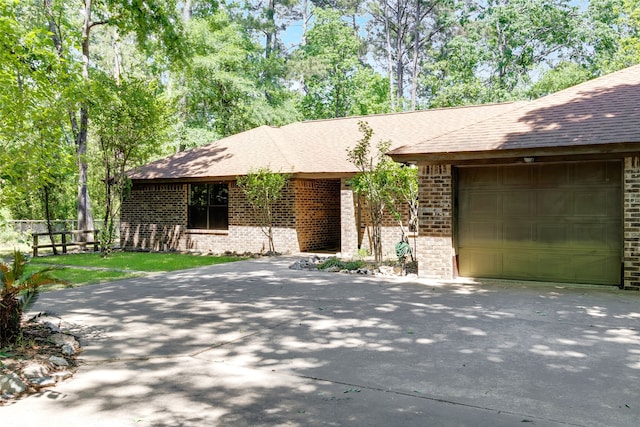 110 Dickens Landing Dr, Livingston, TX 77351 - single story home with roof with shingles, brick siding, fence, concrete driveway, and an attached garage