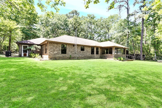 110 Dickens Landing Dr, Livingston, TX 77351 - back of house with a lawn and brick siding