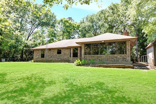 110 Dickens Landing Dr, Livingston, TX 77351 - rear view of property featuring brick siding, a lawn, fence, and a chimney