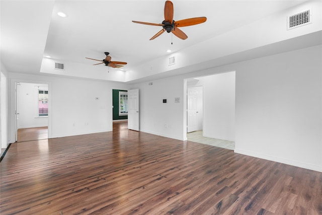 720 W Alabama St, Houston, TX 77006 - unfurnished living room featuring ceiling fan, wood finished floors, recessed lighting, and a raised ceiling