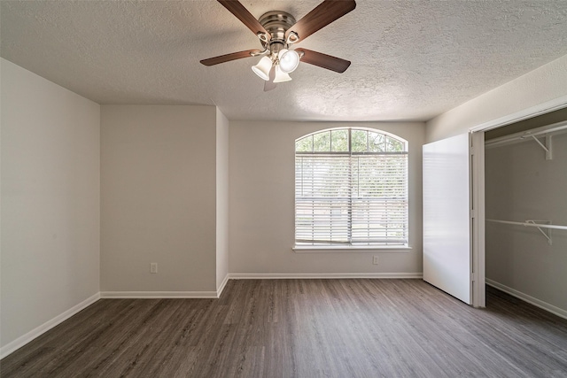 unfurnished bedroom with wood finished floors, a textured ceiling, and a ceiling fan
