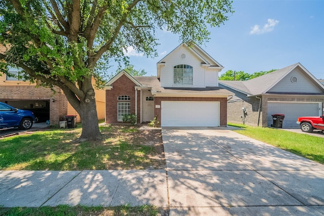 traditional home with brick siding, an attached garage, driveway, and a front yard
