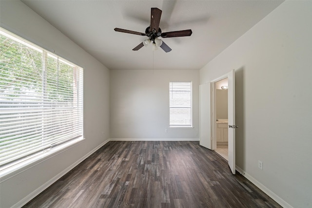 spare room with ceiling fan, baseboards, and dark wood-style floors