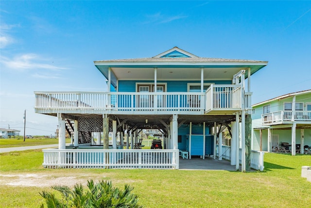 4025 6th St, Galveston, TX 77554 - rear view of property featuring a wooden deck, a yard, and stairs