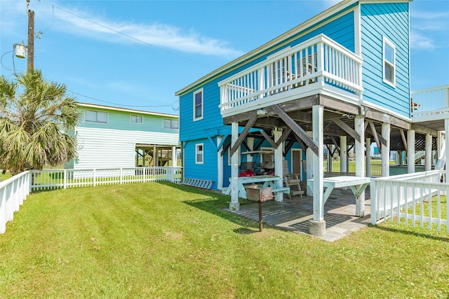 4025 6th St, Galveston, TX 77554 - rear view of property with a wooden deck, a lawn, and a fenced backyard