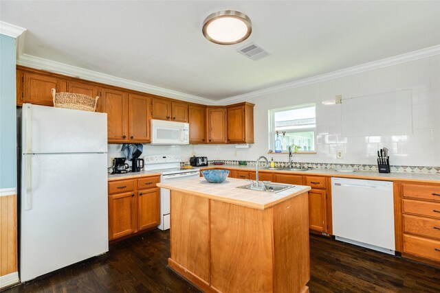 4025 6th St, Galveston, TX 77554 - kitchen featuring an island with sink, tile countertops, ornamental molding, a sink, and white appliances