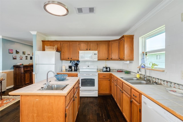 4025 6th St, Galveston, TX 77554 - kitchen featuring tile counters, visible vents, a sink, and white appliances