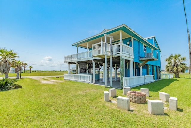 4025 6th St, Galveston, TX 77554 - back of house featuring an outdoor fire pit, a yard, and a deck