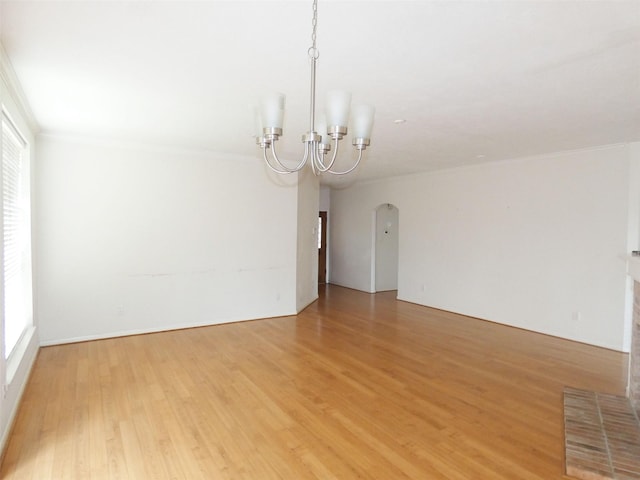 3015 Davey Oaks St, Pearland, TX 77584 - spare room with a chandelier, light wood finished floors, crown molding, and arched walkways