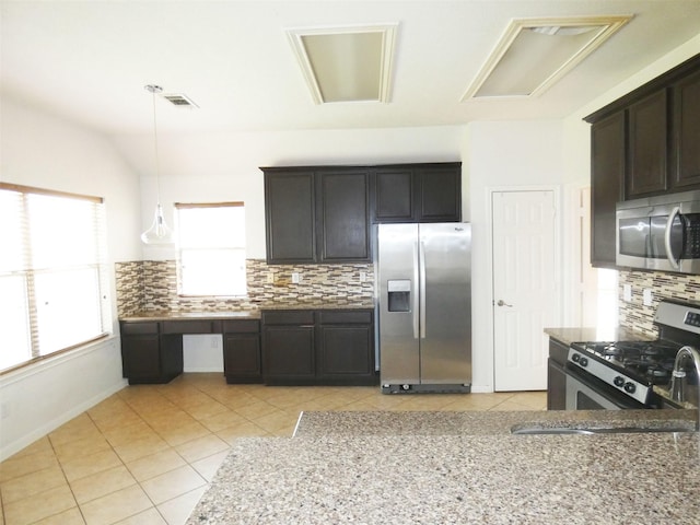 3015 Davey Oaks St, Pearland, TX 77584 - kitchen featuring appliances with stainless steel finishes, light tile patterned floors, tasteful backsplash, light stone countertops, and hanging light fixtures