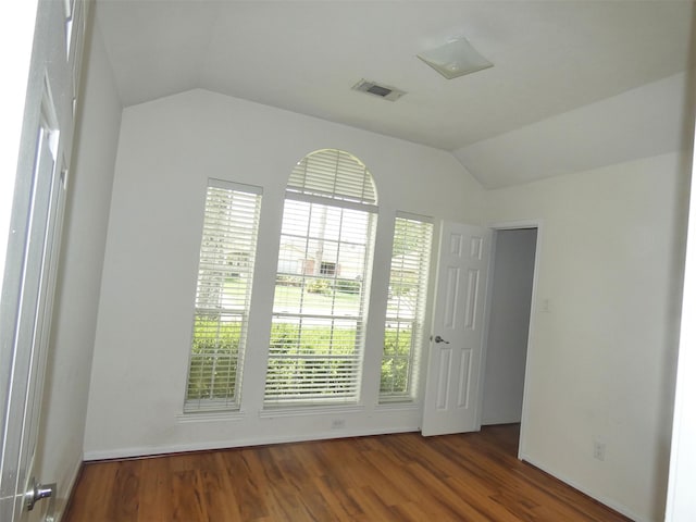 3015 Davey Oaks St, Pearland, TX 77584 - empty room featuring vaulted ceiling, wood finished floors, and plenty of natural light