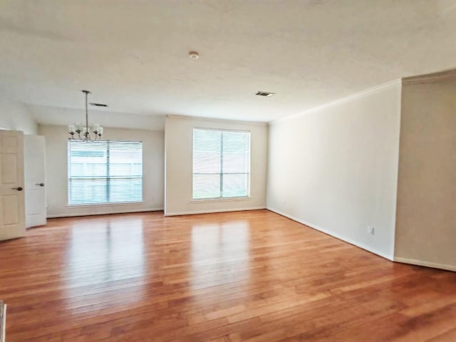 3015 Davey Oaks St, Pearland, TX 77584 - spare room with a chandelier, light wood-type flooring, baseboards, and ornamental molding