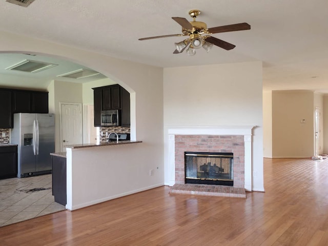3015 Davey Oaks St, Pearland, TX 77584 - unfurnished living room featuring a ceiling fan, light wood-type flooring, and a brick fireplace