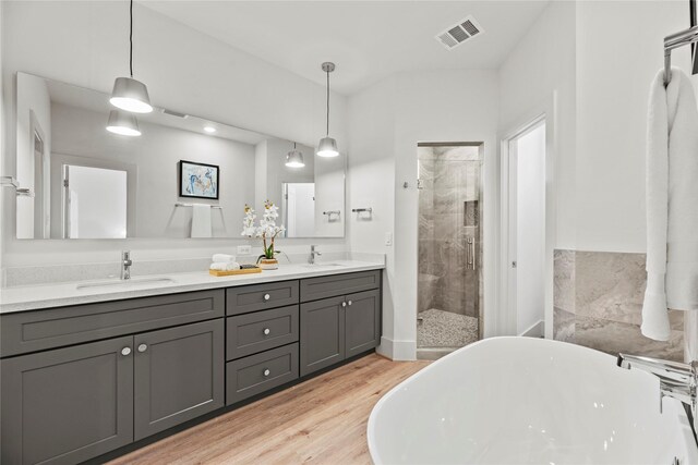 1044 Homer St, Houston, TX 77091 - full bath with a shower stall, wood finished floors, a freestanding tub, and double vanity