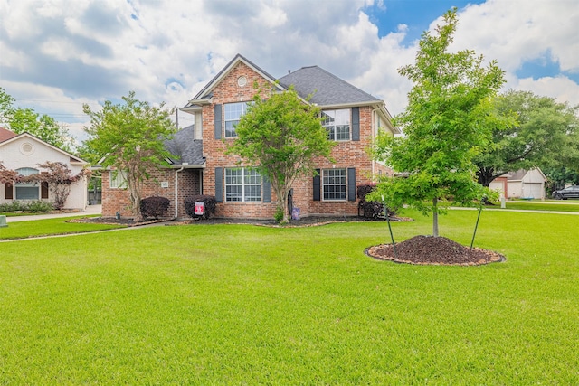 traditional home featuring brick siding, roof with shingles, and a front yard