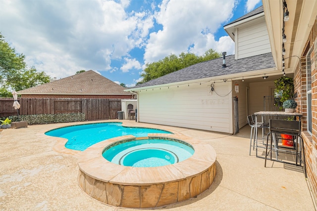 view of swimming pool with a patio area, a fenced backyard, and a pool with connected hot tub
