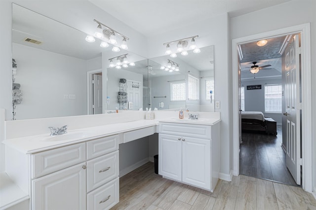 bathroom featuring a sink, double vanity, ensuite bathroom, visible vents, and a ceiling fan
