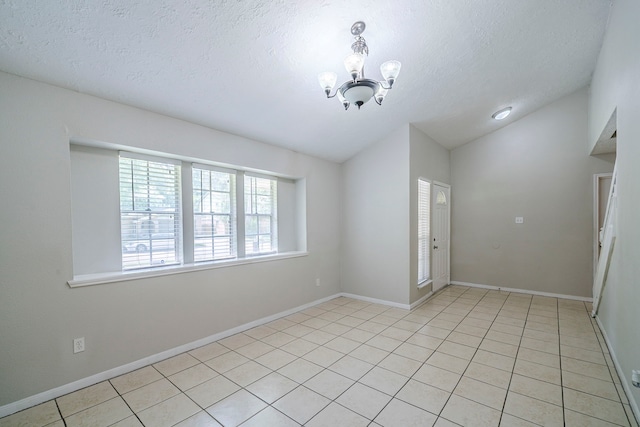 5023 Glendower Dr, Spring, TX 77373 - spare room with light tile patterned floors, vaulted ceiling, a textured ceiling, and a chandelier