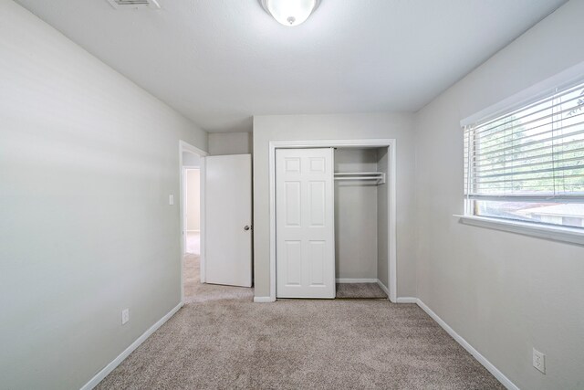 5023 Glendower Dr, Spring, TX 77373 - unfurnished bedroom with a closet, carpet flooring, baseboards, and visible vents
