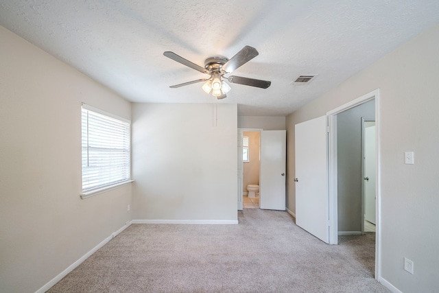 5023 Glendower Dr, Spring, TX 77373 - unfurnished room with a healthy amount of sunlight, a ceiling fan, carpet flooring, and visible vents
