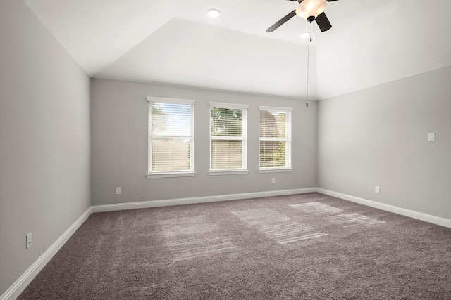 empty room featuring ceiling fan, lofted ceiling, carpet flooring, and baseboards