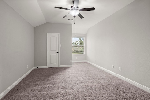 unfurnished room with lofted ceiling, visible vents, carpet floors, baseboards, and ceiling fan
