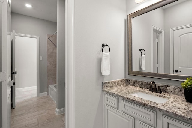 bathroom featuring shower / washtub combination, vanity, and recessed lighting