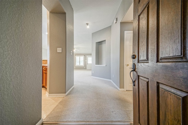 10314 Friars Hl, Houston, TX 77070 - hallway with a textured wall, baseboards, and light carpet