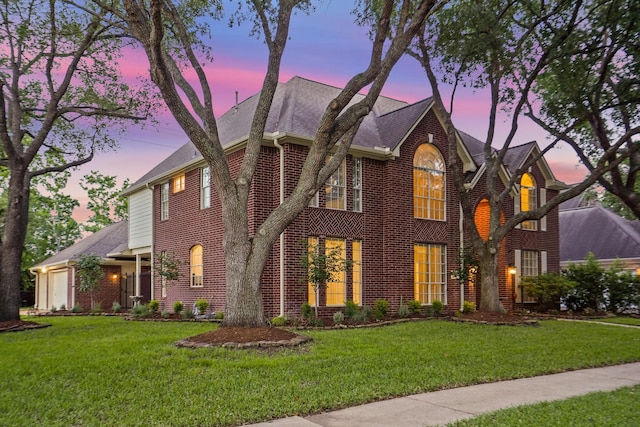 24126 Falcon Point Dr, Katy, TX 77494 - view of front facade with brick siding, a shingled roof, and a yard