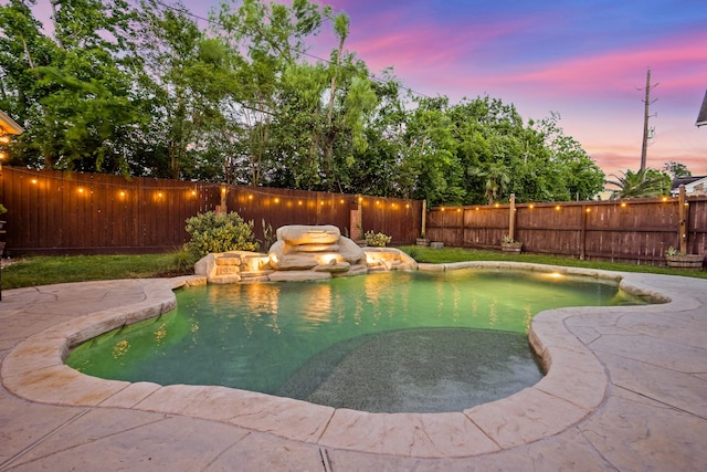 pool at dusk with a patio area, a fenced backyard, and a fenced in pool