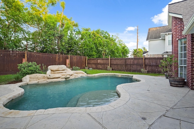 view of swimming pool featuring a fenced backyard, a patio area, and a fenced in pool