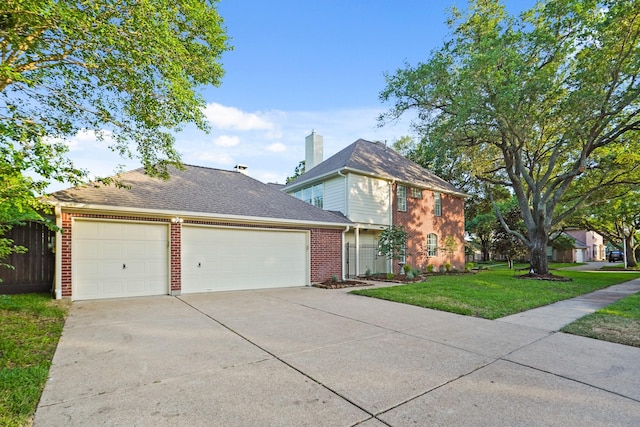 traditional home featuring a front lawn, driveway, fence, brick siding, and an attached garage
