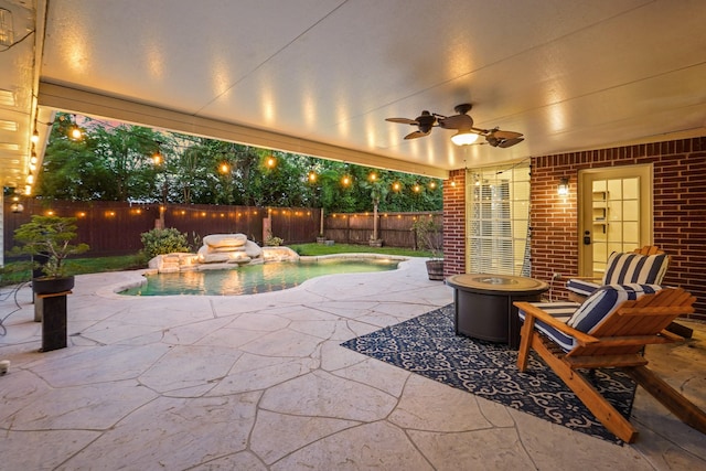 view of patio featuring a fenced in pool, a fenced backyard, and ceiling fan