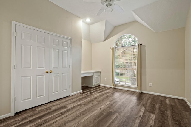 unfurnished bedroom featuring baseboards, wood finished floors, and multiple windows