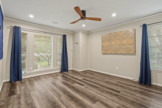 spare room with ceiling fan, wood finished floors, and plenty of natural light